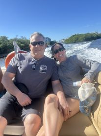 A happy couple enjoys a sunny day on a boat, capturing the joy of their aquatic adventure together.