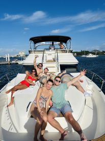 A lively group enjoys a fun day on a yacht, soaking up the sun and celebrating together — perfect for memorable outings on the water.