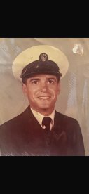 A vintage portrait of a man in a naval uniform, showcasing a proud moment in military service.