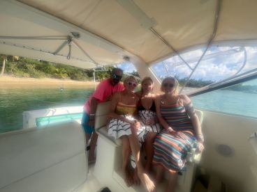 A joyful group of friends enjoys their time aboard a boat, capturing memories in a beautiful setting — perfect for celebrations and fun outings on the water.