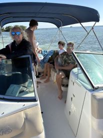 A lively group enjoys their time aboard a boat, capturing the essence of family fun on the water. Perfect for creating lasting memories during a day out.