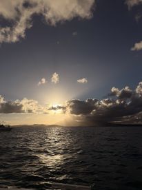 A stunning sunset over the coastline, casting golden rays across the water — a perfect backdrop for evening boat trips and scenic cruises.