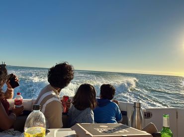 A family enjoys a scenic boat ride at sunset, capturing the joy of togetherness on the water.