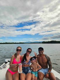 A joyful family enjoys a fun day on the water, showcasing drinks and playful moments aboard a boat — perfect for summer adventures and family outings.