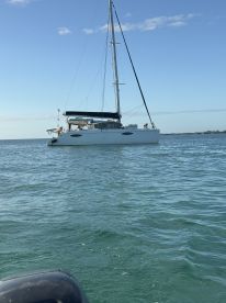 A stunning catamaran anchored in clear waters, showcasing its sleek design and perfect for leisurely sailing adventures.