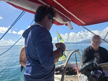 Two individuals engaged in conversation aboard a boat, showcasing the camaraderie and experience of being on the water.