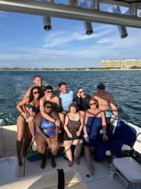 A lively group of friends enjoys a fun day on the water, capturing memories aboard a boat. Perfect for celebrations and group outings.