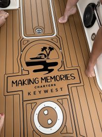 Close-up of the deck featuring the 'Making Memories Charters' logo in Key West, showcasing the inviting atmosphere for a memorable boating experience.