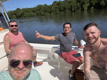 A group of friends enjoys a sunny day on the water, capturing smiles and camaraderie aboard their boat — perfect for memorable outings and adventures.