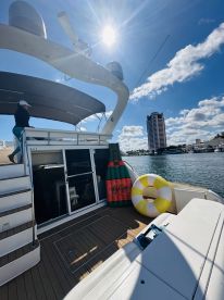 A cozy interior view of a yacht featuring comfortable seating and amenities, perfect for relaxing on the water.