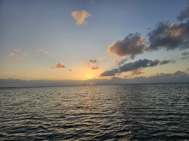 A stunning sunset over tranquil waters, capturing the serene beauty of nature — perfect for romantic evenings or peaceful boat rides.