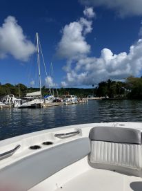 A view of the interior seating area of a boat, showcasing comfortable seating and a glimpse of the marina in the background — perfect for relaxing before setting out on the water.