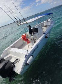 A captain navigates a Sea Fox boat equipped for fishing, showcasing the perfect setup for a day on the water.
