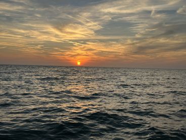 A stunning sunset over the ocean, capturing the tranquil beauty of the water as day transitions to night.