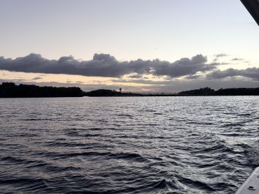 A serene view of the water at sunset, showcasing the tranquil beauty of the surroundings, ideal for peaceful boating experiences.