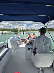 A group of friends enjoys a day on the water aboard a boat, capturing the essence of fun and relaxation in a beautiful setting.