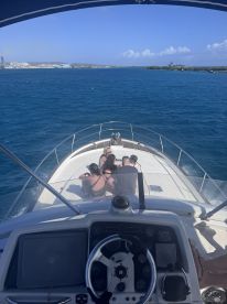 A group of friends enjoys a sunny day on the boat, capturing the essence of fun and adventure on the water.