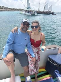 A couple enjoys a sunny day on the water, sharing drinks and smiles aboard a boat — perfect for romantic getaways or fun outings.