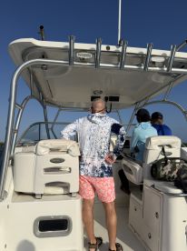 A view inside the boat's helm area, showcasing guests enjoying the ride. The spacious seating and controls highlight the comfort and functionality of this vessel.