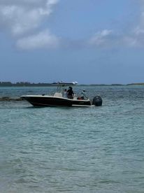 A boat navigates through clear waters, showcasing an active on-water experience with guests aboard, perfect for exploring scenic destinations.