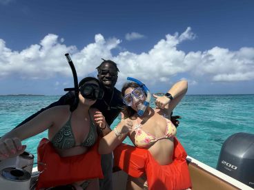 A lively group prepares for snorkeling in the beautiful turquoise waters, showcasing the excitement of ocean adventures.