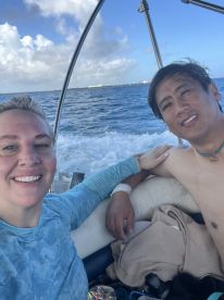 A happy couple enjoys a moment on a boat, capturing their adventure on the open ocean — perfect for memorable outings and romantic getaways.