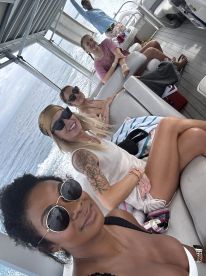 A lively group of friends enjoys their time aboard a boat, capturing the essence of fun and camaraderie on the water.