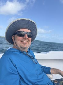 A man enjoys a day on the water, showcasing the perfect atmosphere for relaxation and adventure on a boating trip.