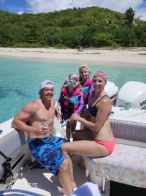 A joyful family enjoys a day on the water, ready for snorkeling adventures with a beautiful beach backdrop — perfect for creating unforgettable memories.