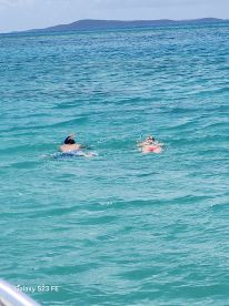 Two snorkelers explore the vibrant underwater world in crystal-clear waters, showcasing the excitement of marine adventures.