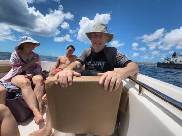 A cheerful group enjoys a sunny day on the water, capturing the essence of fun and relaxation aboard a boat.