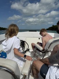 Two children enjoy a day on the water aboard a boat, capturing the essence of family fun and adventure on the sea.