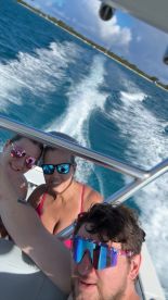 A lively selfie of three friends enjoying a fun day on the water, capturing the excitement of their boating adventure.