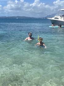 A family enjoys snorkeling in crystal-clear waters, creating unforgettable memories during their aquatic adventure.