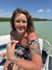 A joyful woman enjoys her time on a boat, showcasing a beautiful day on the water — perfect for memorable outings and adventures.
