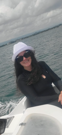 A woman enjoys a day on the water, showcasing the joy of boating adventures. Perfect for highlighting fun experiences on the sea.