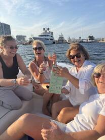 A joyful group of friends celebrates on a boat, raising their glasses for a toast — perfect for memorable gatherings and boat parties.