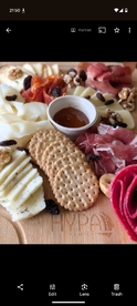 A beautifully arranged charcuterie platter featuring a variety of cheeses, meats, and accompaniments, perfect for onboard snacking during a boat trip.