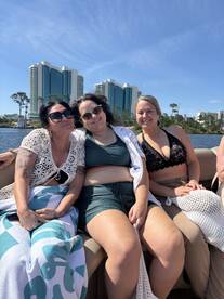 A group of friends enjoys a sunny day on a boat, capturing the essence of fun and relaxation on the water.