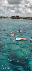 Two friends enjoy a fun snorkeling experience in crystal-clear waters, showcasing the excitement of underwater adventures.