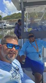 A group of friends enjoys their time aboard a boat, capturing a fun moment together. Perfect for showcasing the joy of boating adventures.