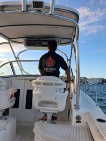 A view of the helm inside a boat, featuring a captain at the controls, showcasing the comfortable seating and modern console — perfect for navigating the waters.