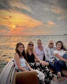A group of friends enjoys a beautiful sunset on a boat, capturing the perfect moment for a memorable outing on the water.