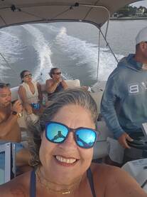 A joyful group enjoys a boat ride, capturing memories and laughter on the water. Perfect for celebrating special moments with friends.