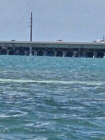 An unclear view of a structure over water, possibly a bridge or pier, with no identifiable subjects or activities.