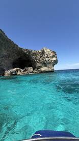 A stunning view of a rocky coastline against crystal-clear turquoise waters, perfect for exploring hidden coves and enjoying the beauty of nature.