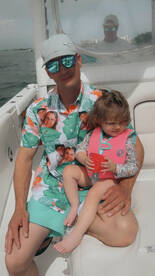 A father and his young daughter enjoy a sunny day on the boat, creating cherished family memories together.