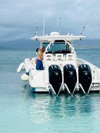 A group of people interacts on a boat in clear waters, showcasing a fun day on the water — perfect for family outings or adventure trips.
