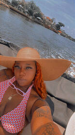 A vibrant selfie of a woman enjoying a sunny day on a boat, capturing the essence of relaxation and fun on the water.