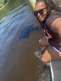 A joyful moment captured as a person enjoys the water, showcasing the fun and relaxation of outdoor activities on the water.